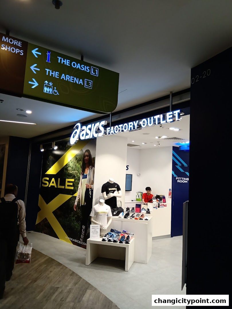 Asics Factory Outlet store entrance with mannequins displaying apparel and shoes.