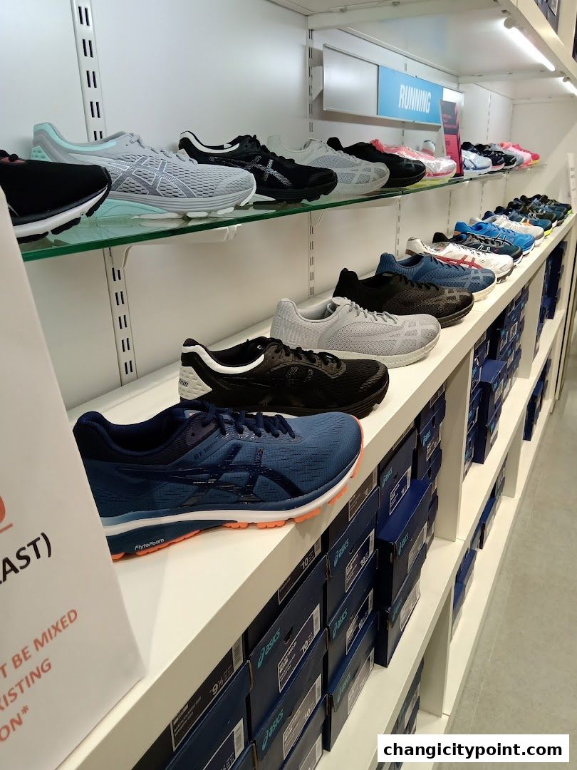 A display of various running shoes on shelves in a retail store.