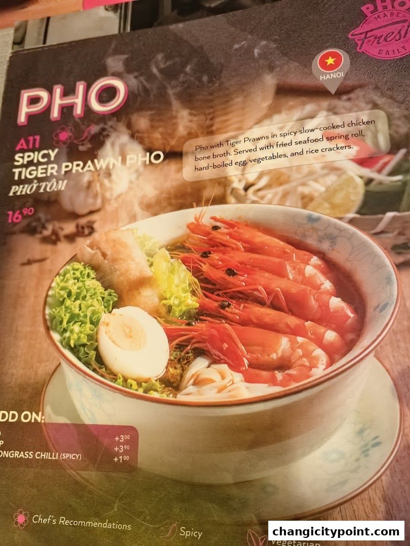 A menu item featuring spicy tiger prawn pho with a detailed description and price.