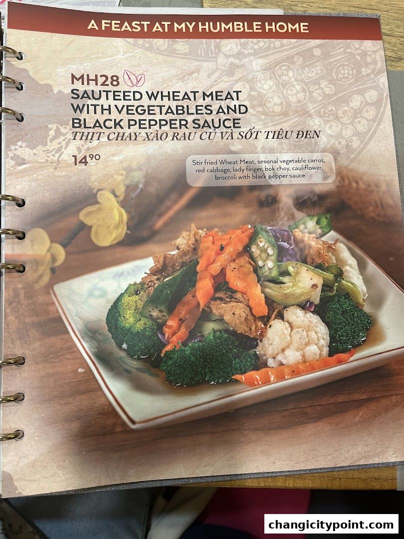 A menu page featuring a dish of sauteed wheat meat with vegetables and black pepper sauce.