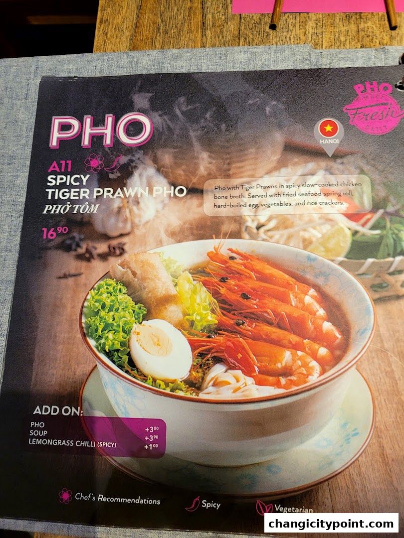 A menu page showcasing a spicy tiger prawn pho with add-on options.