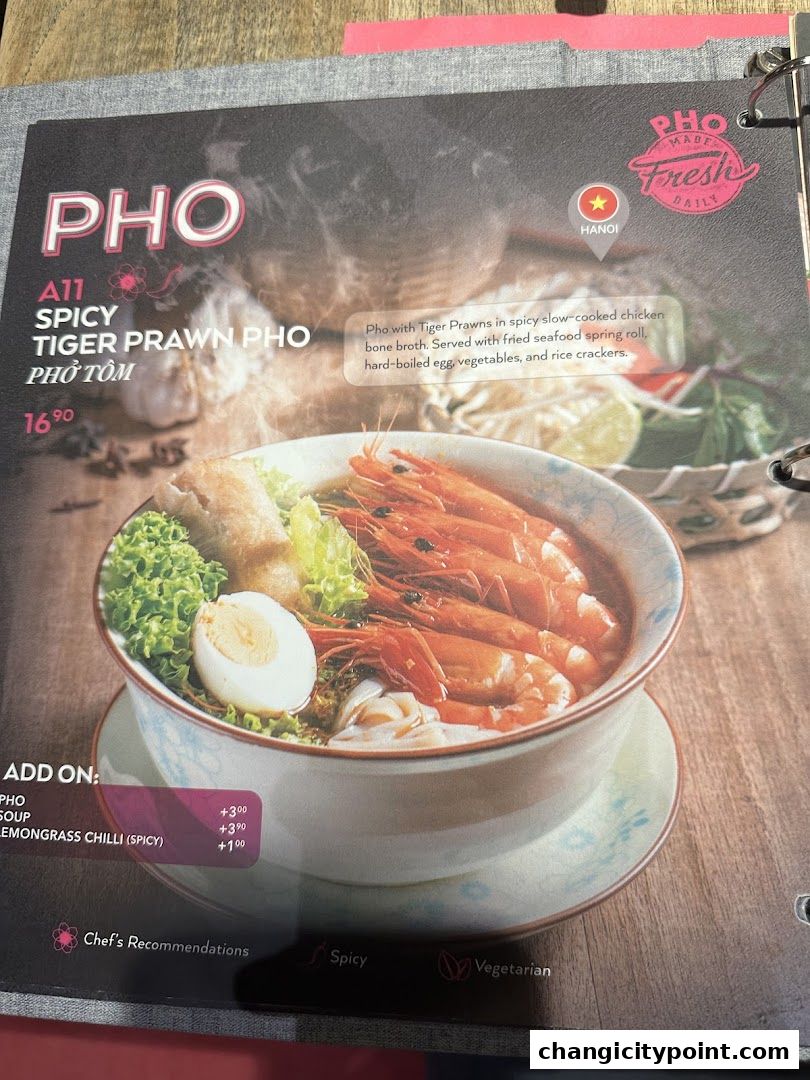 A menu page showcasing a spicy tiger prawn pho with a detailed description and add-on options.