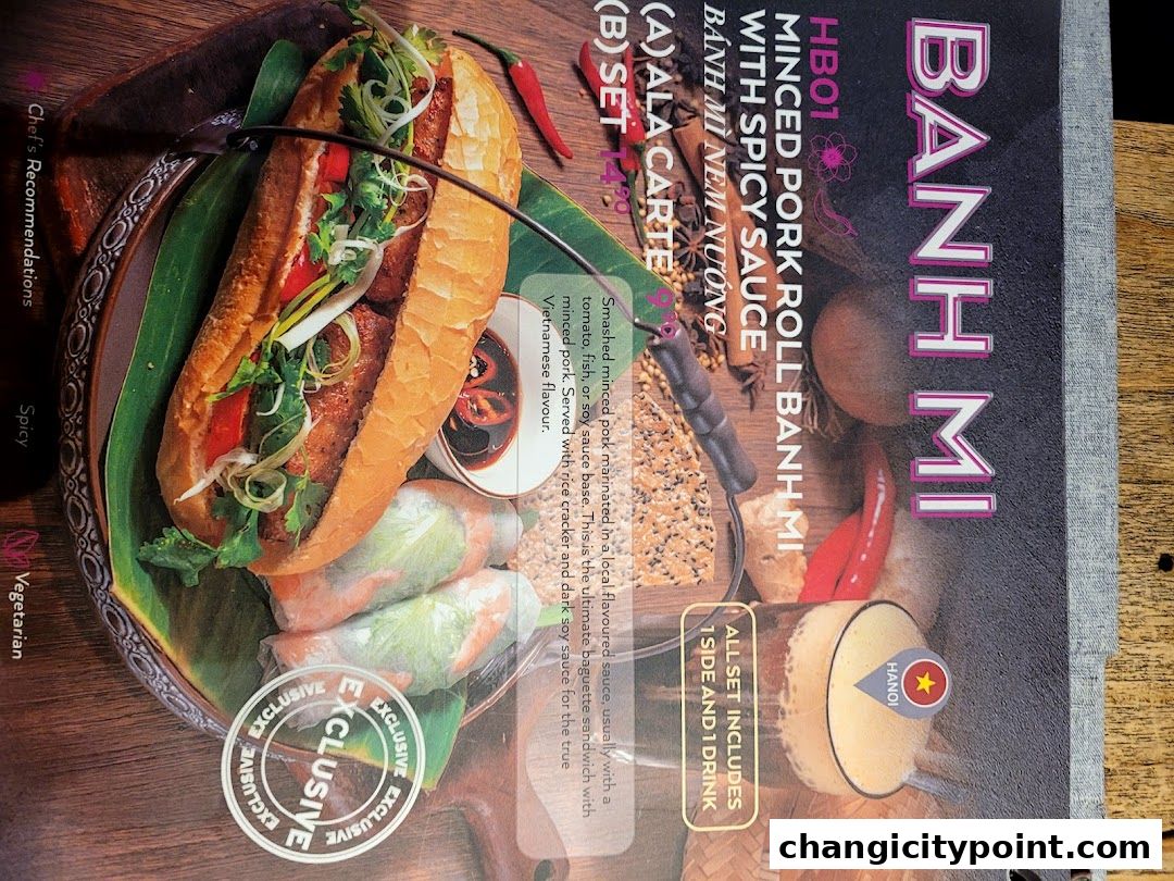 A delicious Banh Mi sandwich with minced pork and spicy sauce, served with spring rolls.