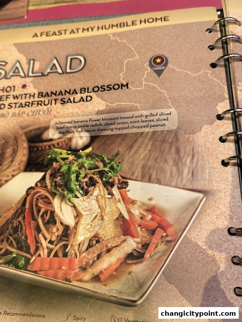 A menu page featuring a salad dish with beef and starfruit, with a description.