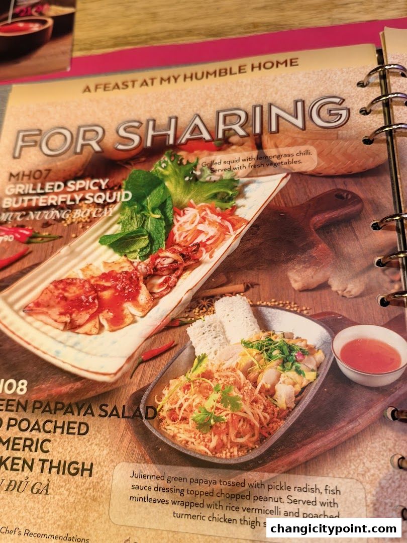 A menu page showcasing dishes for sharing, including grilled squid and green papaya salad.