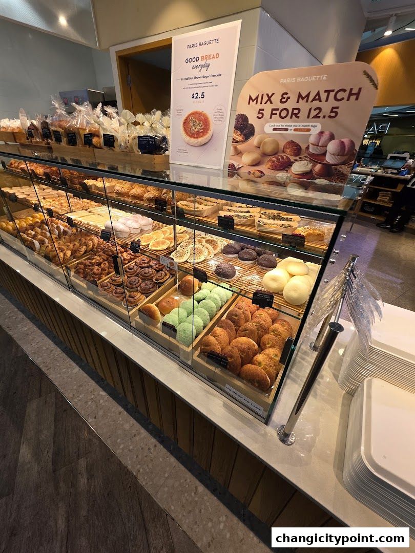 A display of freshly baked bread and pastries at Paris Baguette.