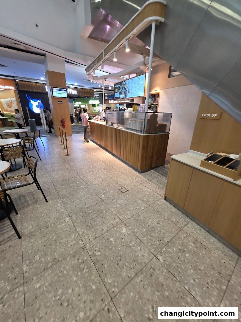 Paris Baguette Changi City Point shop interior with a wooden counter and menu display.