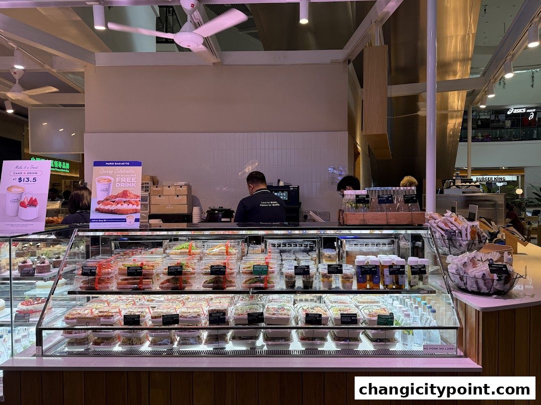 Paris Baguette Changi City Point display case filled with various food items and drinks.