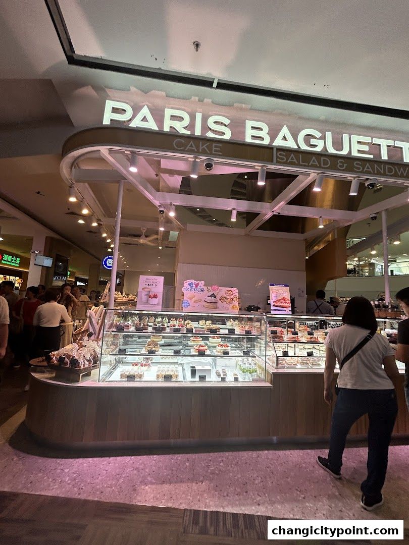 Paris Baguette shop front with display cases full of cakes and pastries.