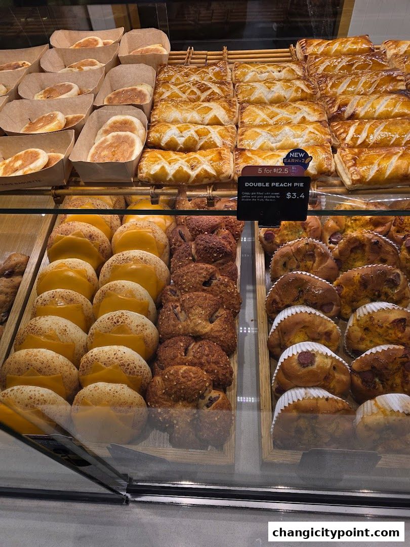 A display of freshly baked pastries and pies at Paris Baguette.