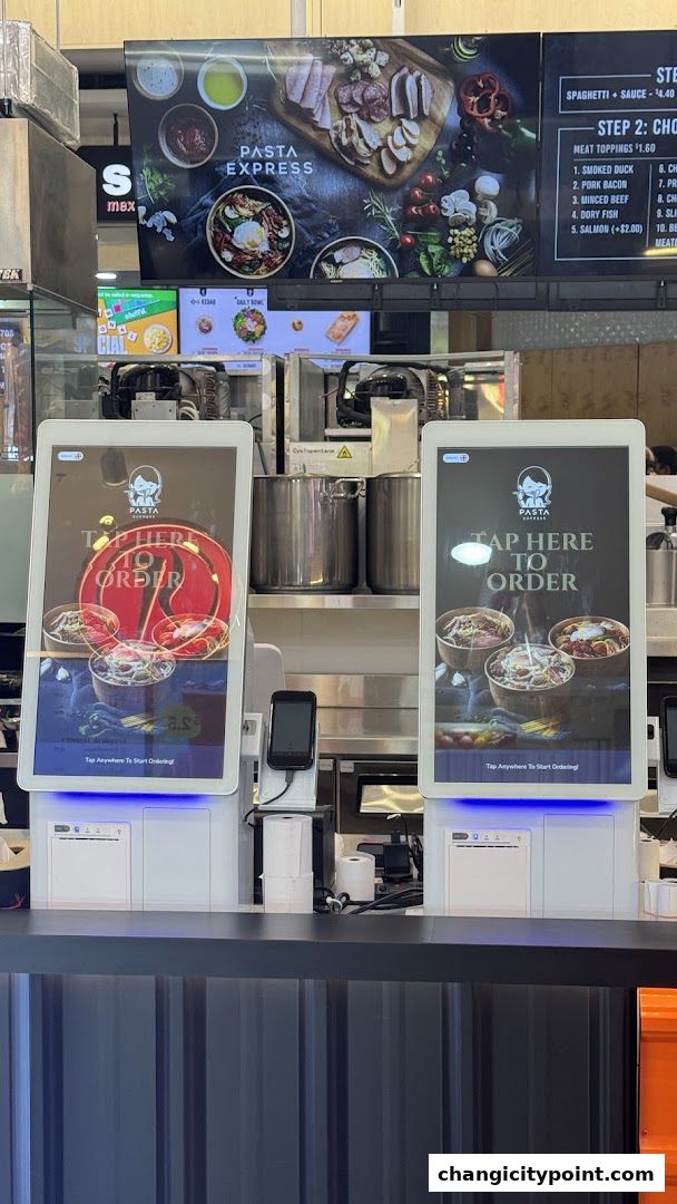 Pasta Express self-order kiosks with menu display above.