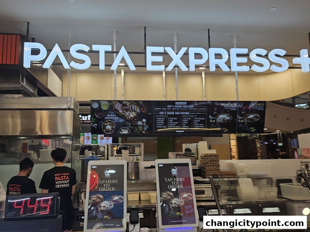 The Pasta Express shop front with illuminated signage and digital ordering screens.