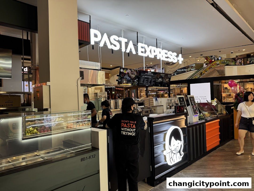 The Pasta Express shop front with a neon sign and display cases.
