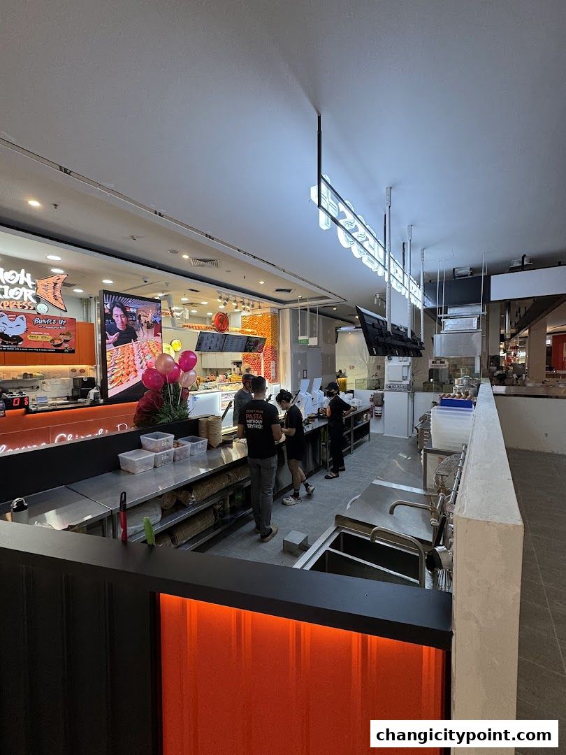 Interior view of Pasta Express at Changi City Point with staff preparing food.
