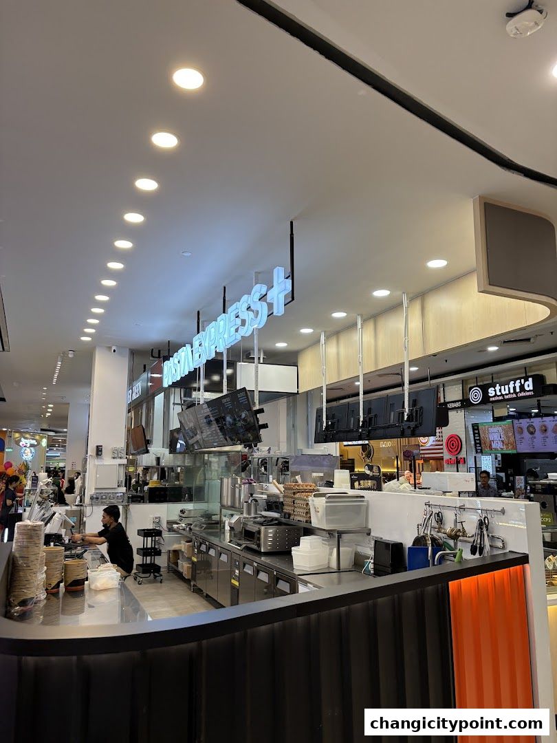 Interior view of Pasta Express with staff preparing food behind the counter.