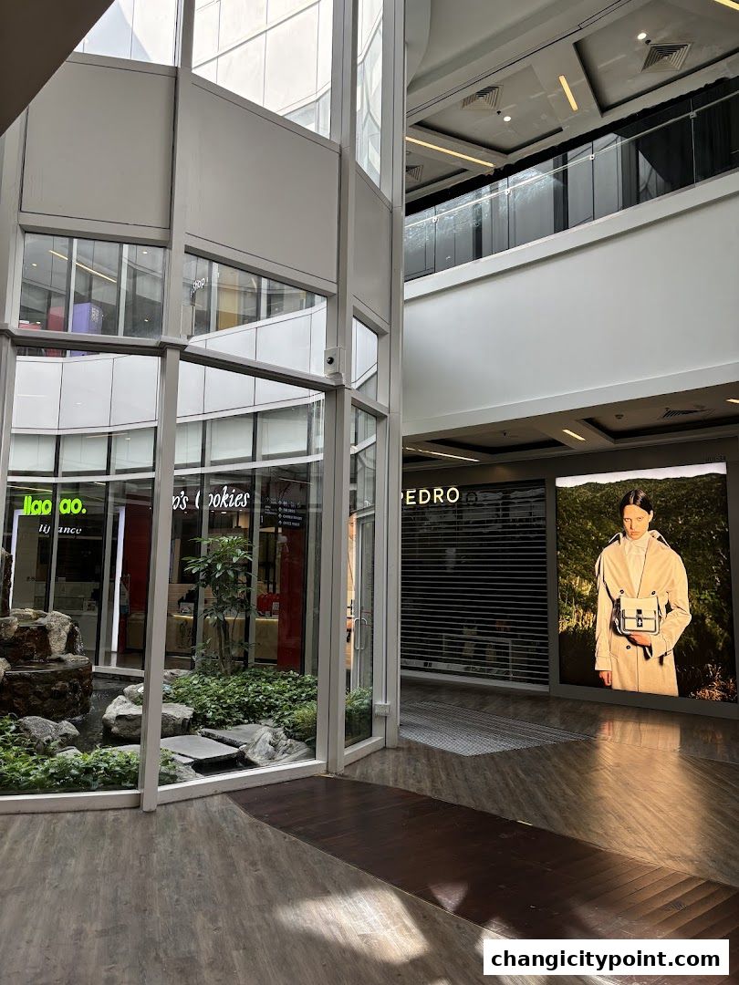 The PEDRO shop entrance with a large advertisement featuring a model.