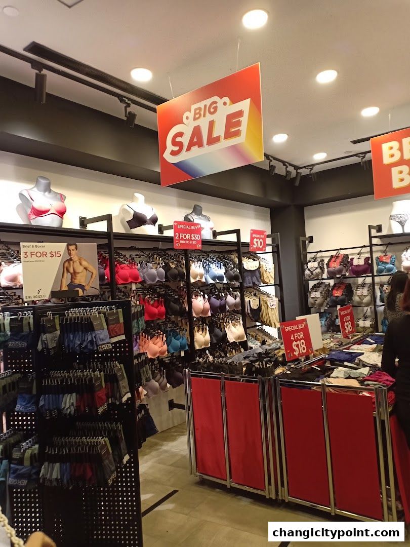 Interior of a lingerie shop with a big sale sign and various undergarments on display.