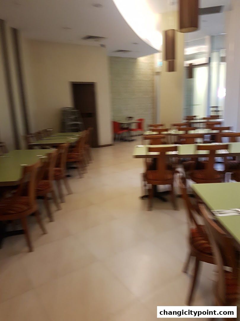 Interior view of a restaurant with tables and chairs set up for dining.