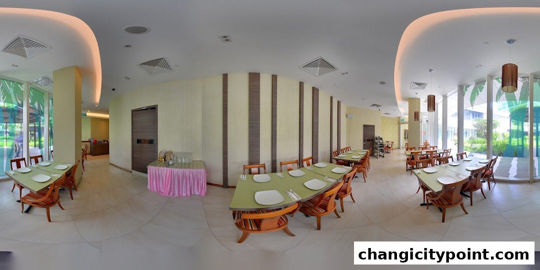 Interior view of a restaurant with tables set for dining and large windows.