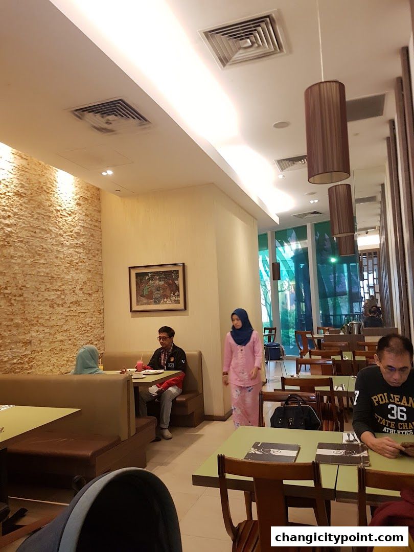 Interior view of Pondok Kartika restaurant with diners and seating.