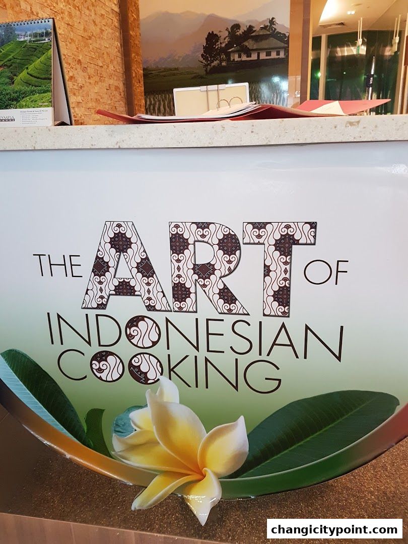 A sign reads 'The Art of Indonesian Cooking' with a flower and leaves.