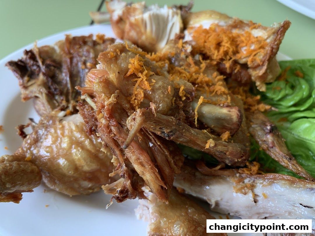 A close-up of a plate of crispy fried chicken with lettuce garnish.