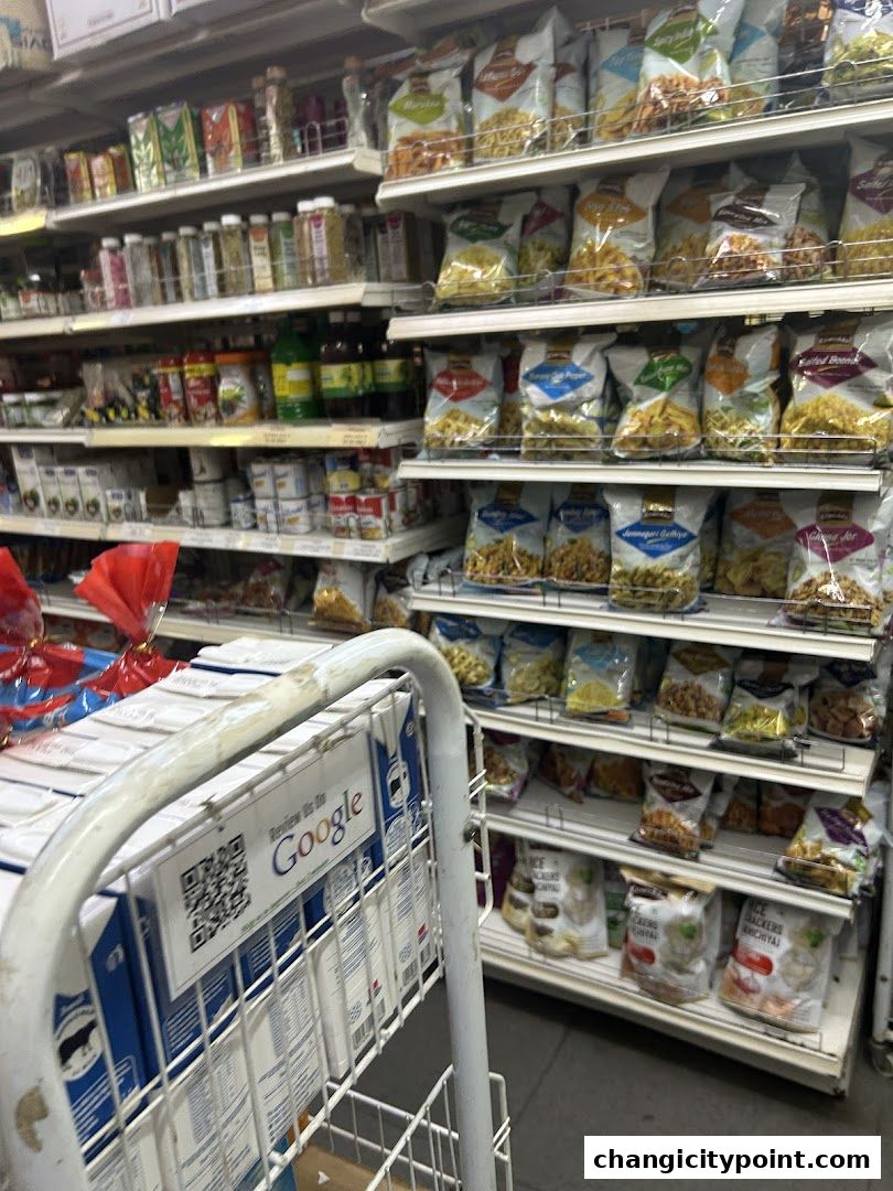 Shelves stocked with various Indian grocery items, snacks, and packaged goods.
