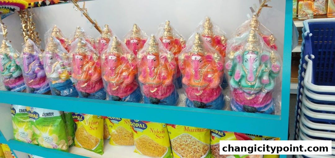 Colorful Ganesha idols and Indian snacks displayed on shelves at Ponni Indian Groceries.