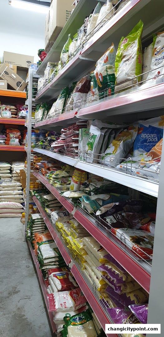 Aisle of shelves stocked with various bags of rice and Indian groceries.