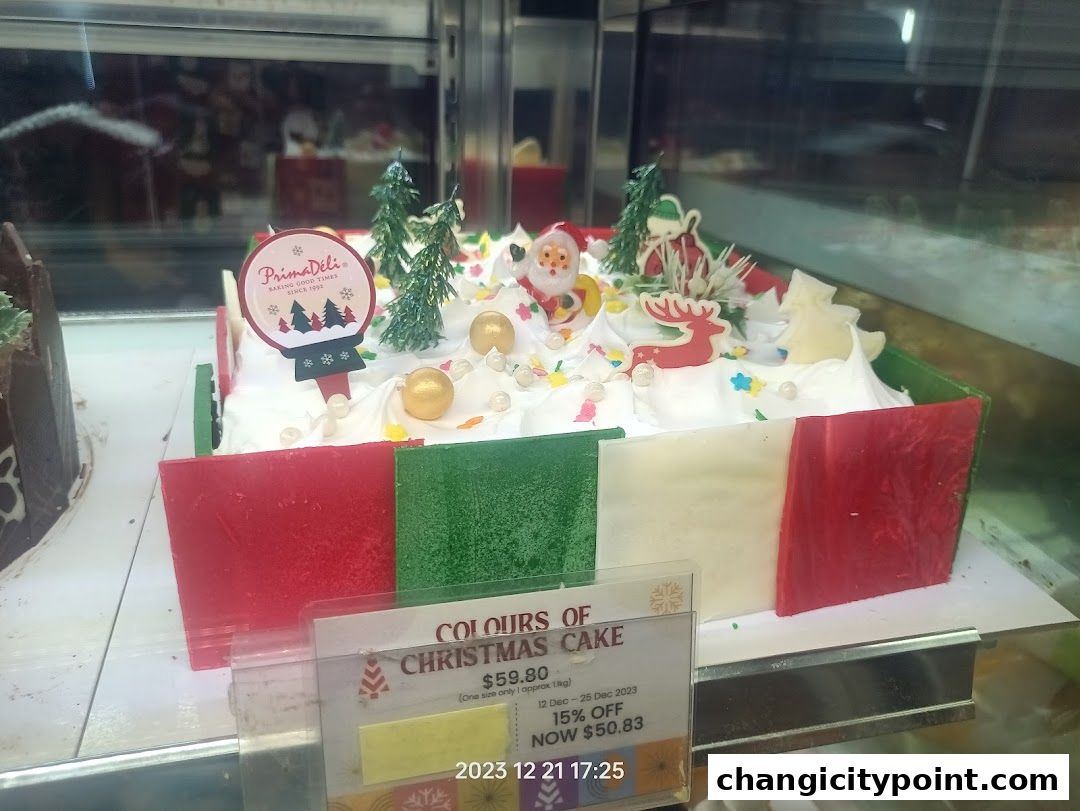 A festive Christmas cake decorated with Santa, reindeer, and trees from PrimaDéli.