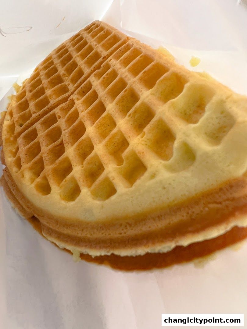 A close-up shot of a golden-brown waffle with a crisp texture.