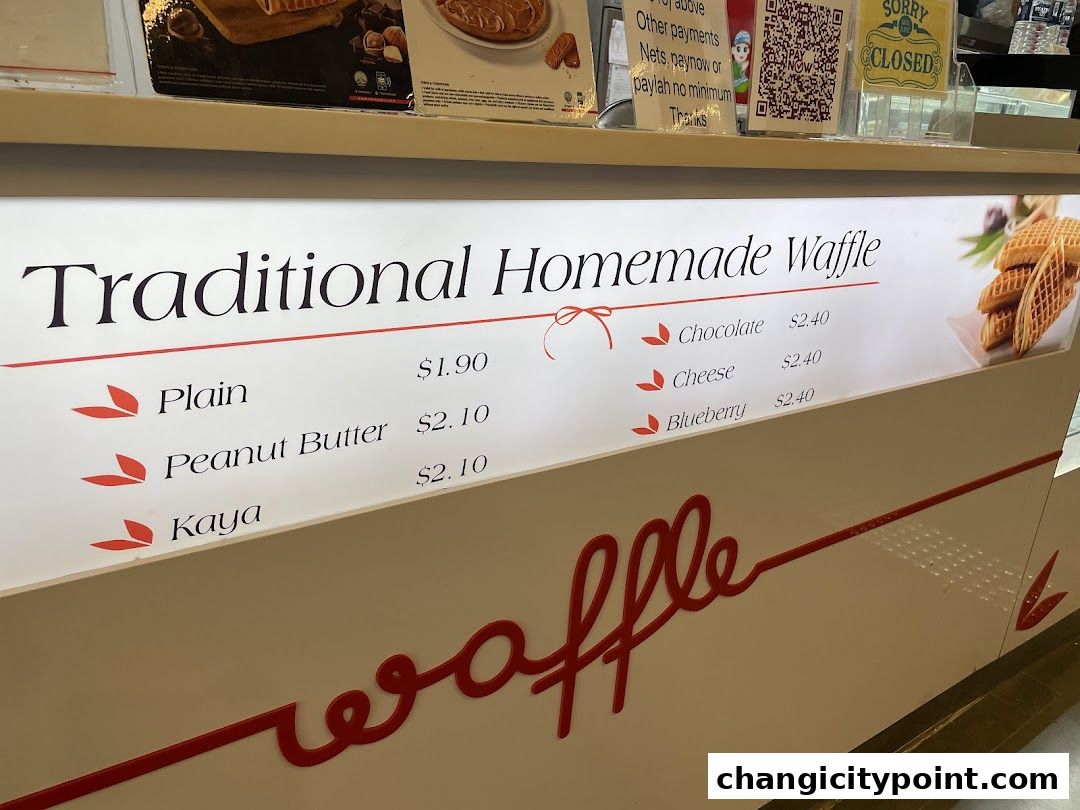A menu board displaying traditional homemade waffles with various flavors and prices.
