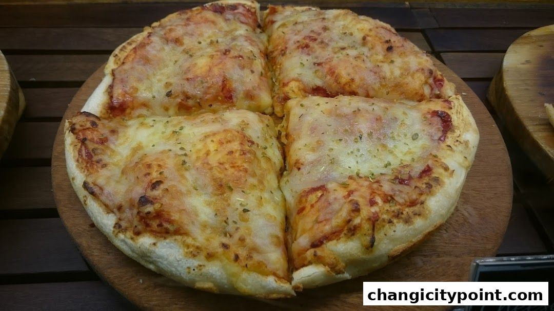 A close-up shot of a freshly baked pizza, cut into four slices, on a wooden board.