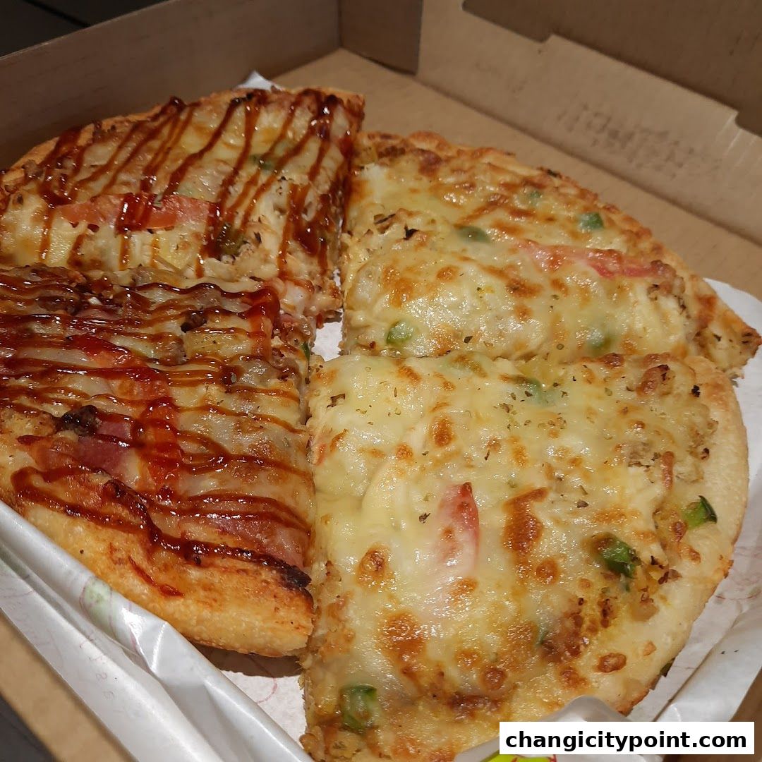 Close-up of delicious pizza slices in a cardboard box, ready to be enjoyed.