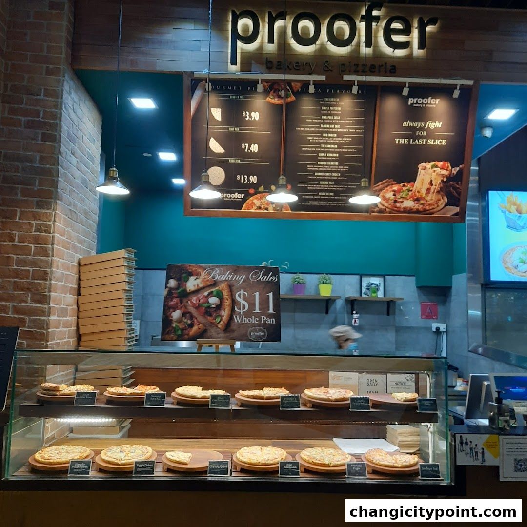 A bakery and pizzeria display with pizzas, menus, and a special offer.