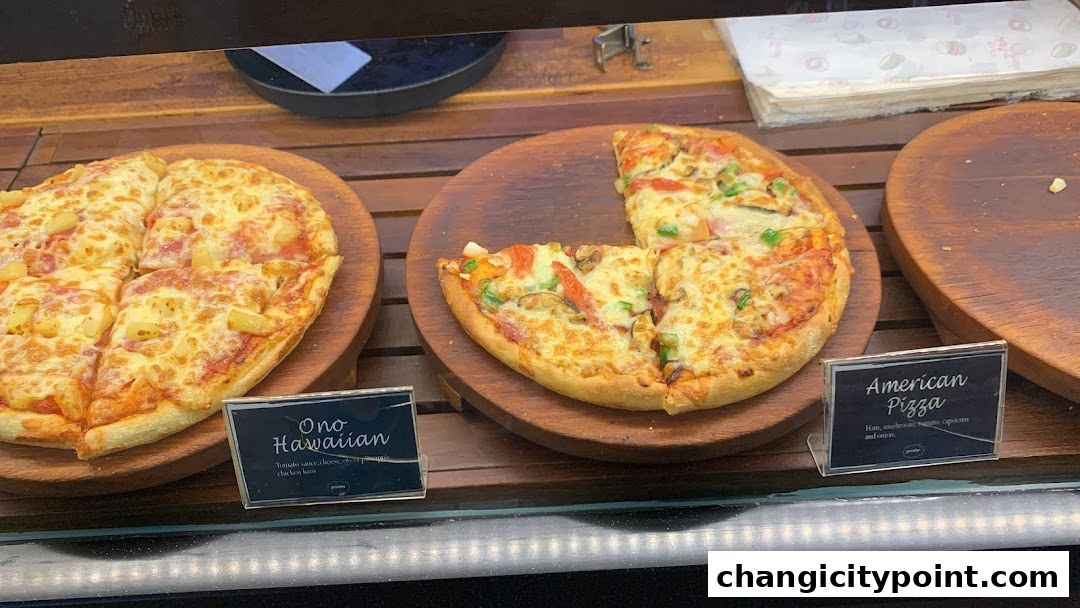 Two pizzas, one Hawaiian and one American, displayed on wooden boards.