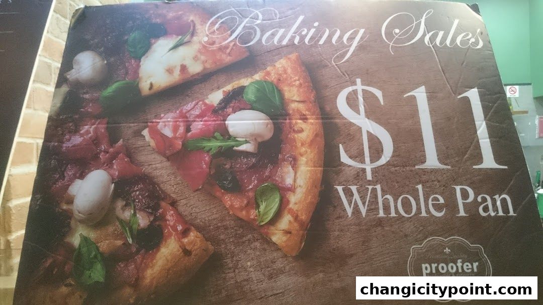 A sign advertising whole pan pizzas for $11 from Proofer Boulangerie.
