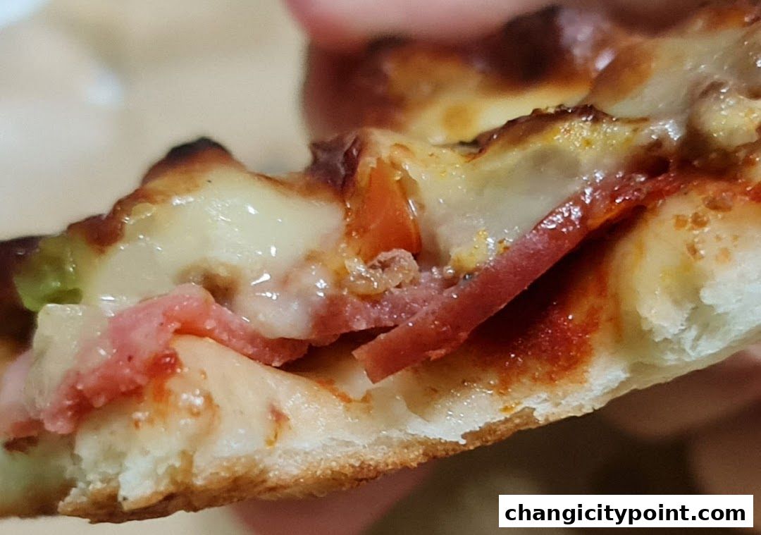 A close-up shot of a delicious slice of pizza with melted cheese and toppings.