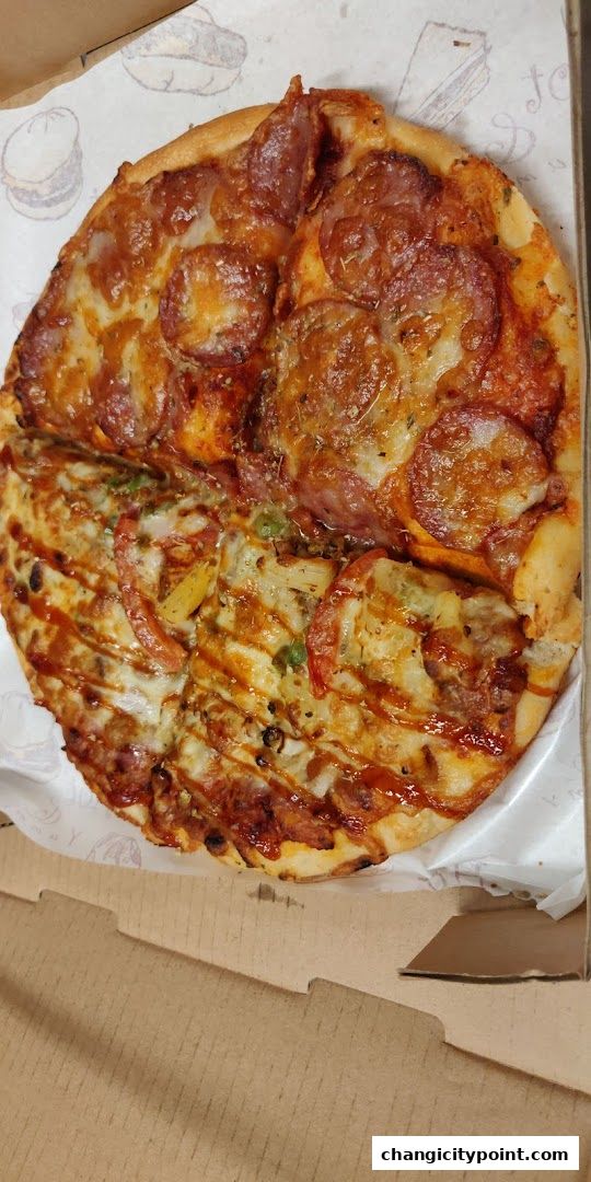A delicious pizza with two different toppings, served in a cardboard box.