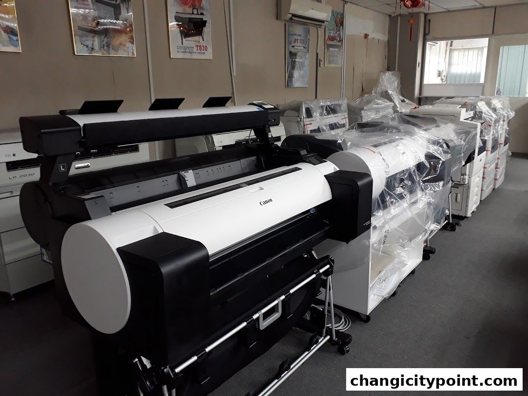 Interior view of a shop displaying various large format printers and copiers.
