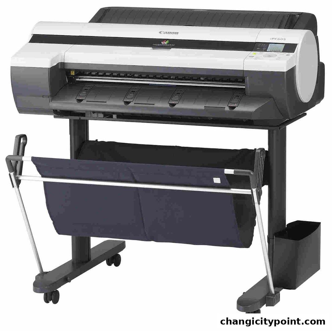 A large format Canon IPF605 printer with a media collection basket.