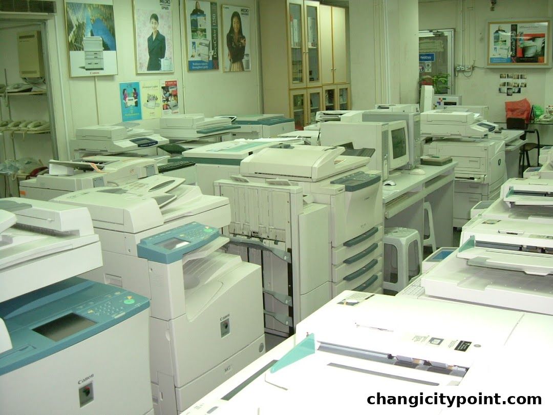 Interior view of a shop filled with printers, copiers, and office equipment.