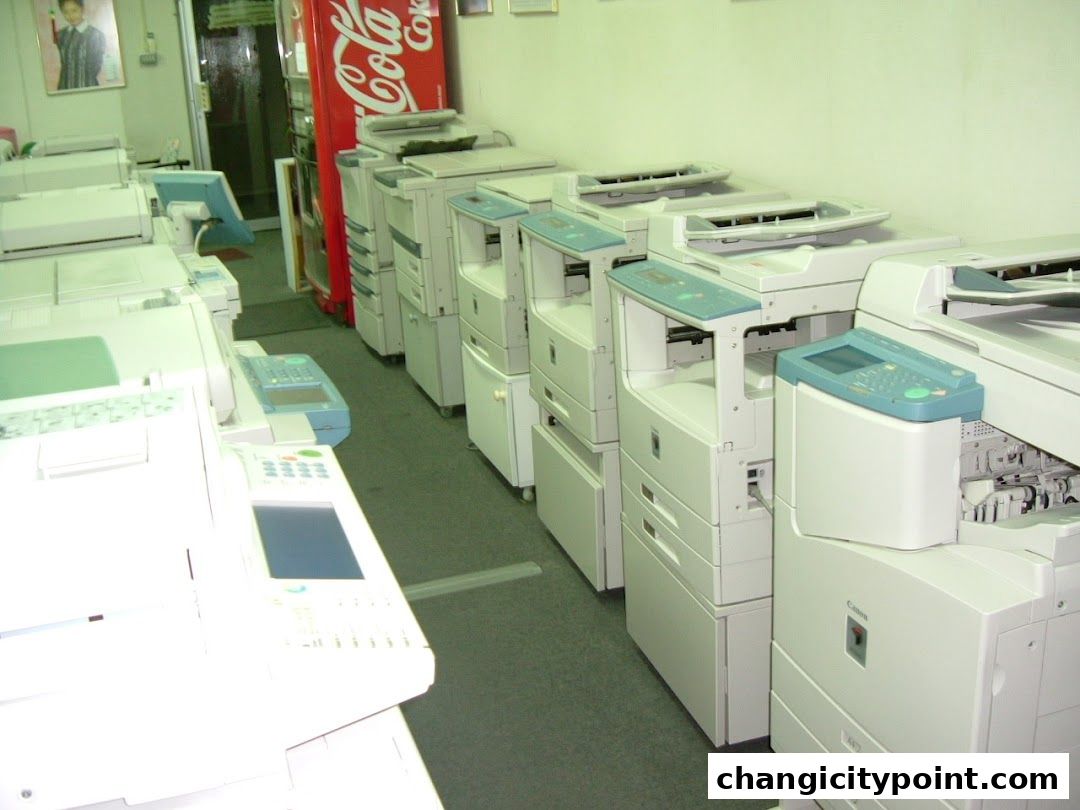 Rows of printers and copiers are displayed inside a business.