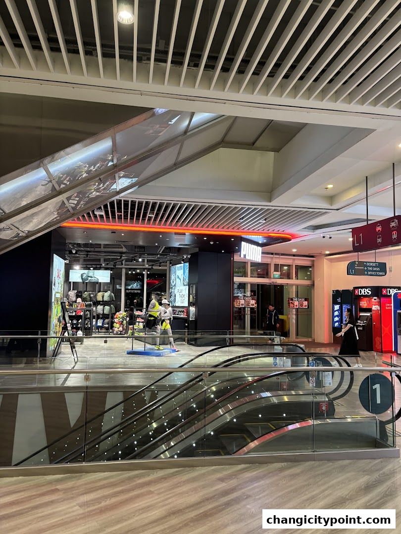 Puma Outlet store entrance with displays of athletic wear and mannequins.