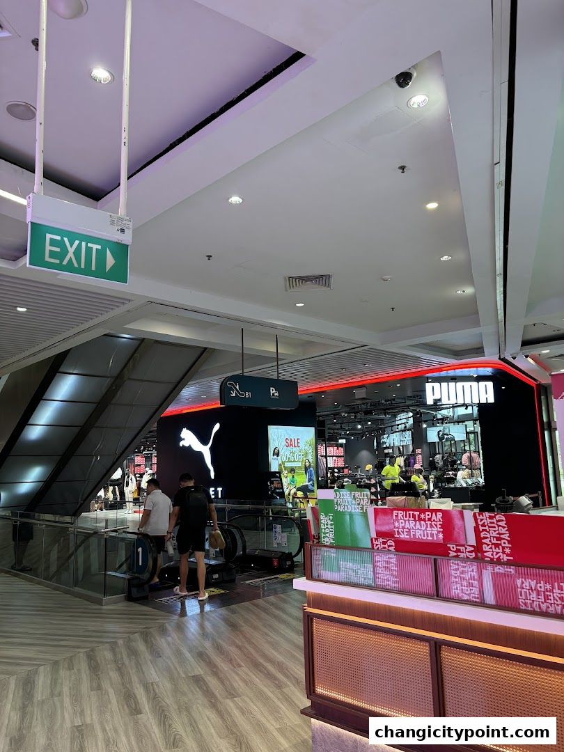 Puma Outlet store entrance with escalators and signage.