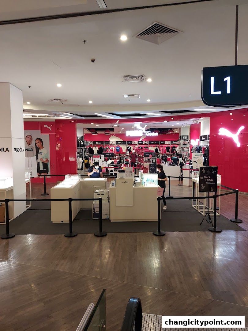 Puma Outlet store interior with merchandise displayed and checkout counters.