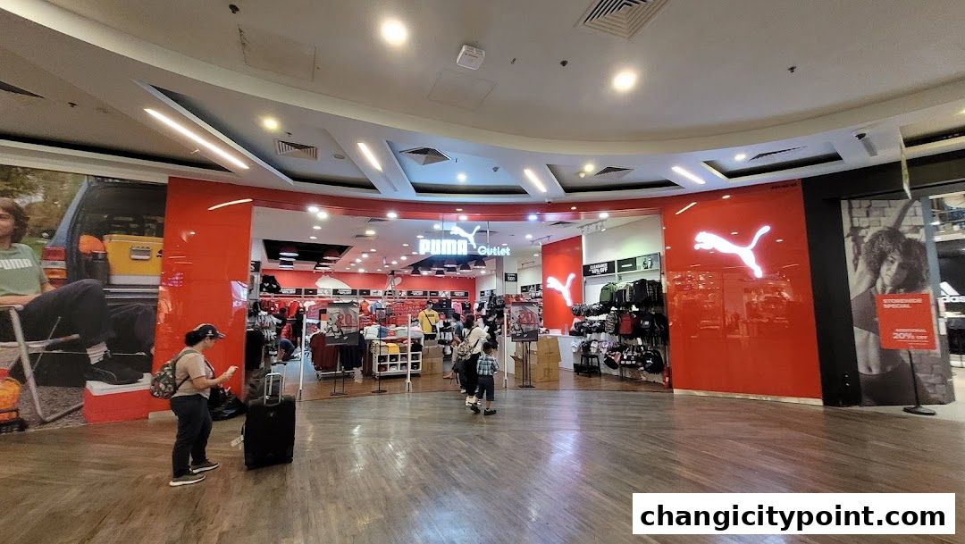 Puma Outlet store entrance with displays of apparel and accessories.