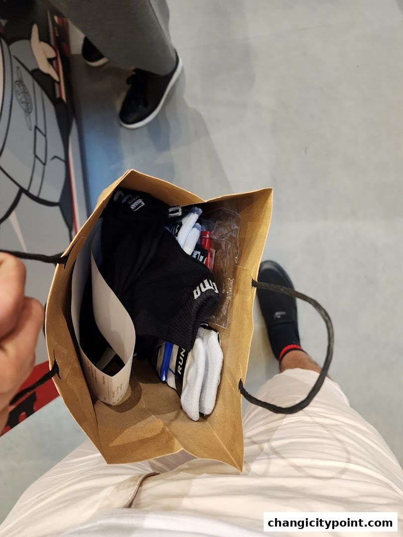 A shopping bag filled with PUMA socks and a receipt.