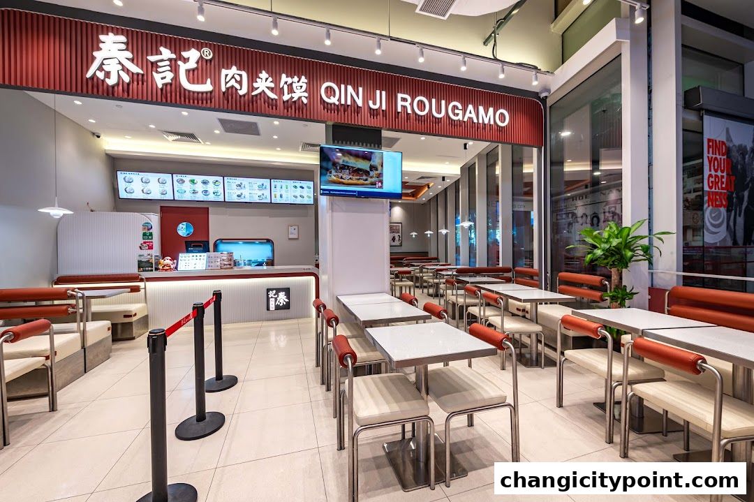 Interior view of Qin Ji Rougamo, a fast-food restaurant with seating and a counter.
