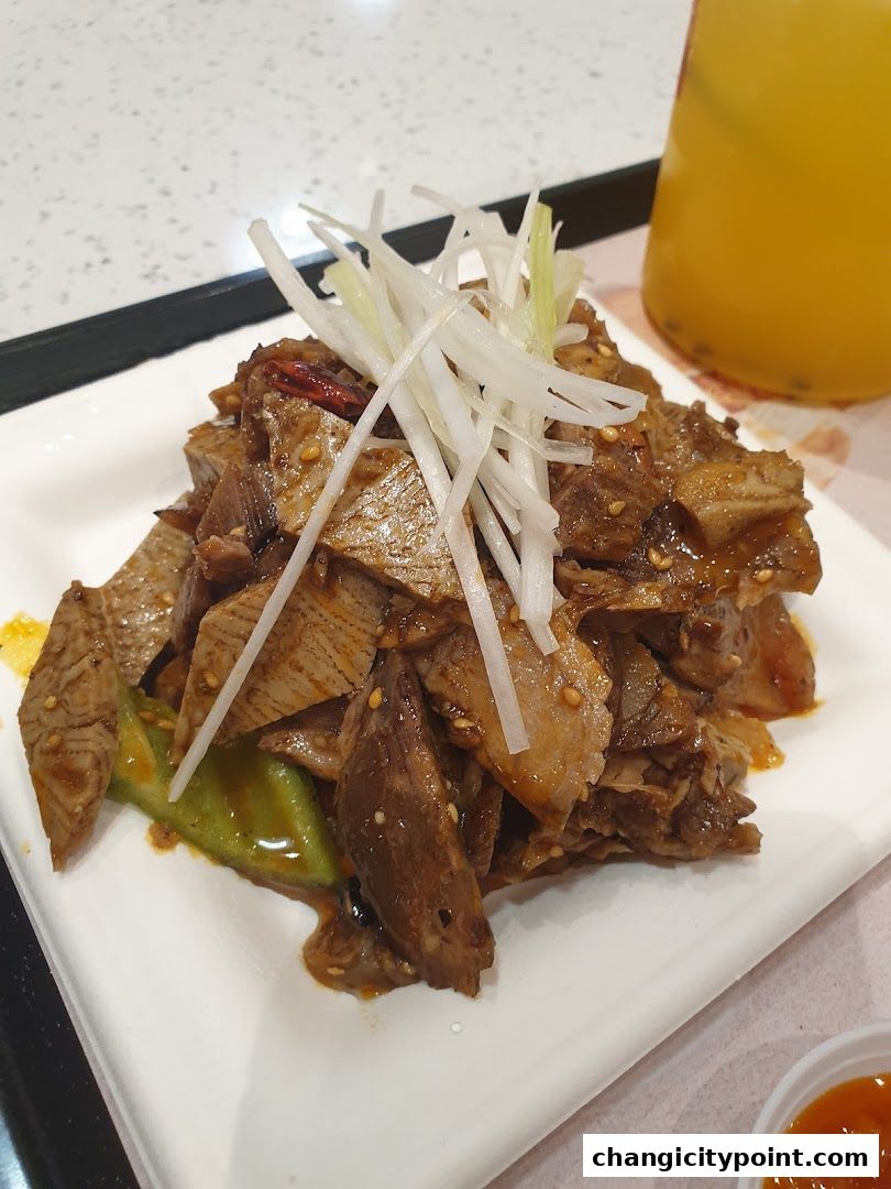 A plate of sliced, seasoned meat with green vegetables and a drink.